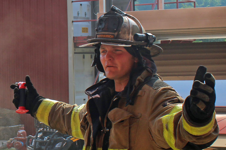 Firefighter in gear without face piece and SCBA