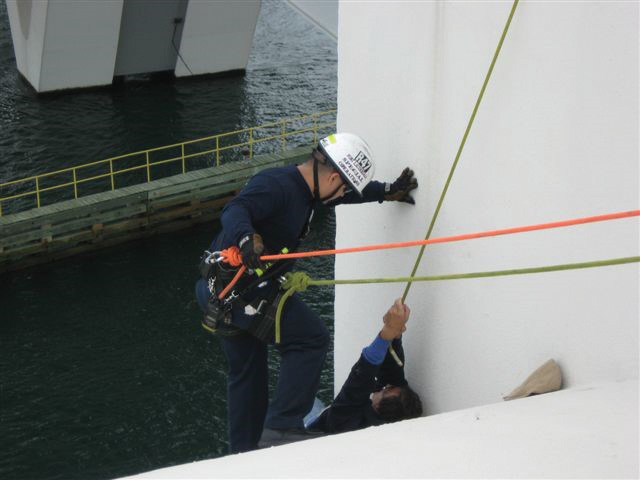 Fort Lauderdale (FL) Firefighter Rolando Busto is being lowered on a Prusik-minded pulley belay (1:1 MA with progress capture), which will stop him if he moves beyond the predetermined location. (Busto has a second rope that he will attach to the patient.) After the rescuer secures the patient, they will be hauled upward with a 3:1 Z-rig MA system.