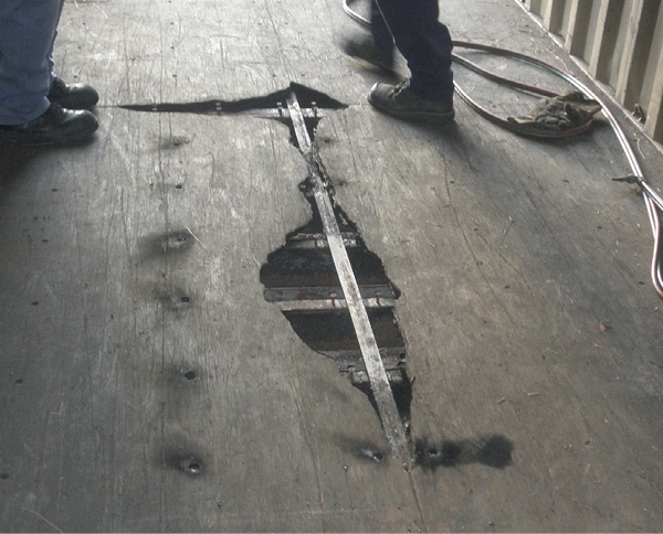 Heat/fire damage from fires in the container below this one. Note the steel floor cross-members under the wood decking. (Photo by author.)