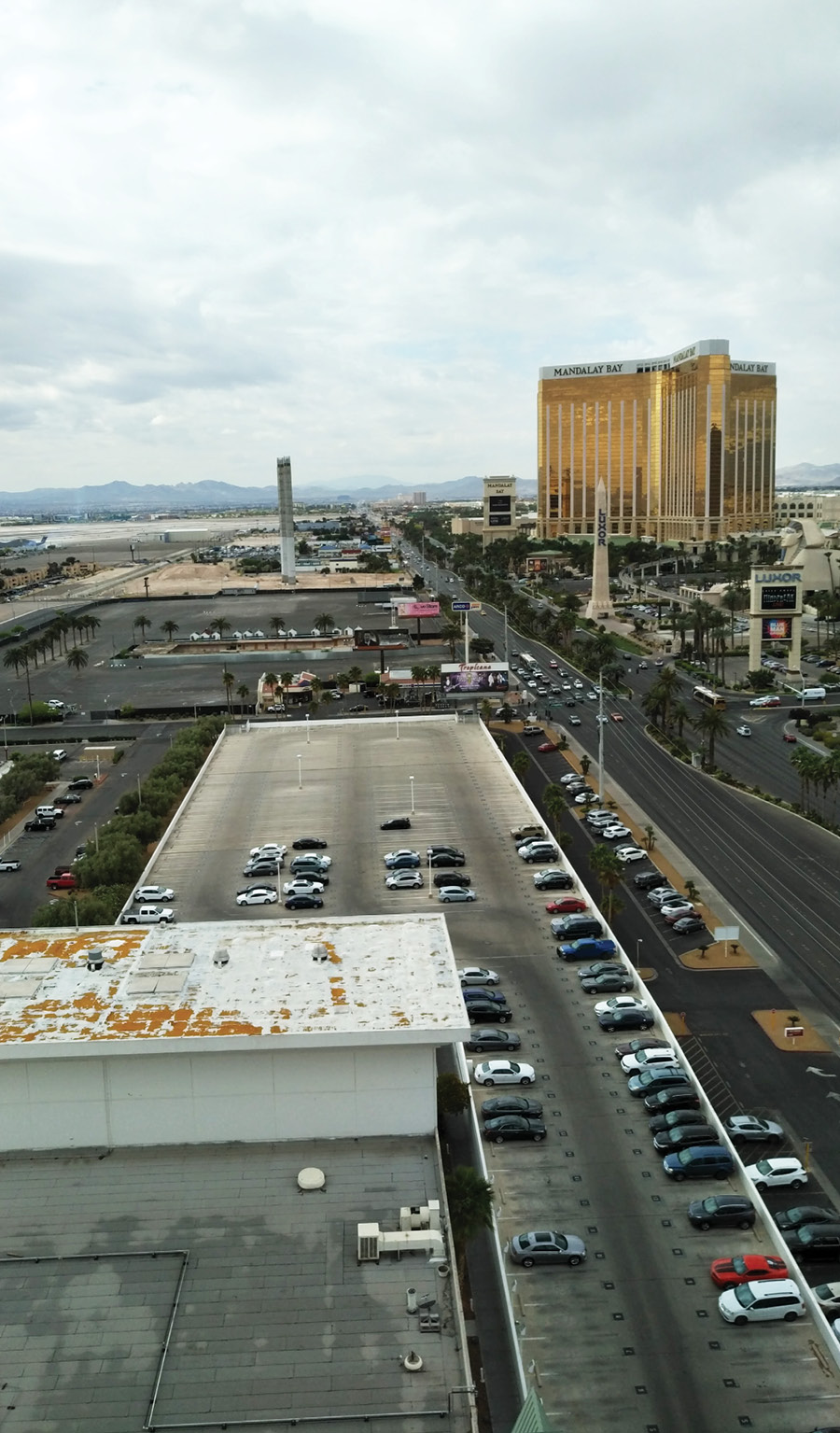 A view from an upper floor of an adjacent hotel months after the incident, showing the concert venue site (beyond the parking garage) and the Mandalay Bay Hotel in the upper right. (Photo by Charles Jennings.) 