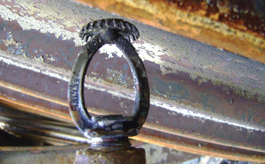 A fused sprinkler head within the rack storage area in AP-6. During the investigation phase, every located sprinkler was found fused.