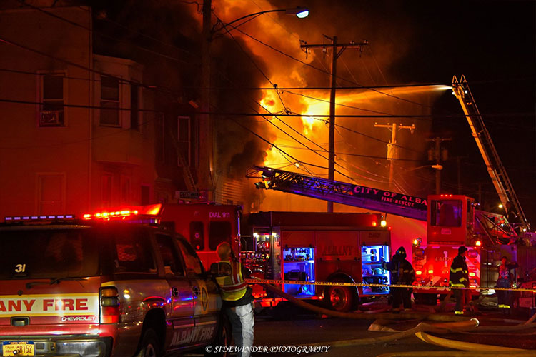 Fire in a row house with fire apparatus