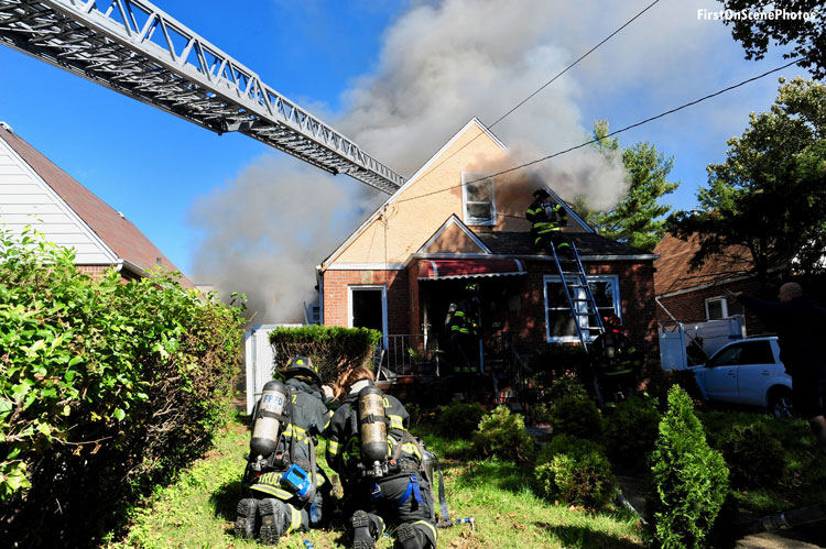 Firefighters battle a house fire