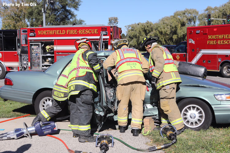 Firefighters work to remove a patient from a pin job