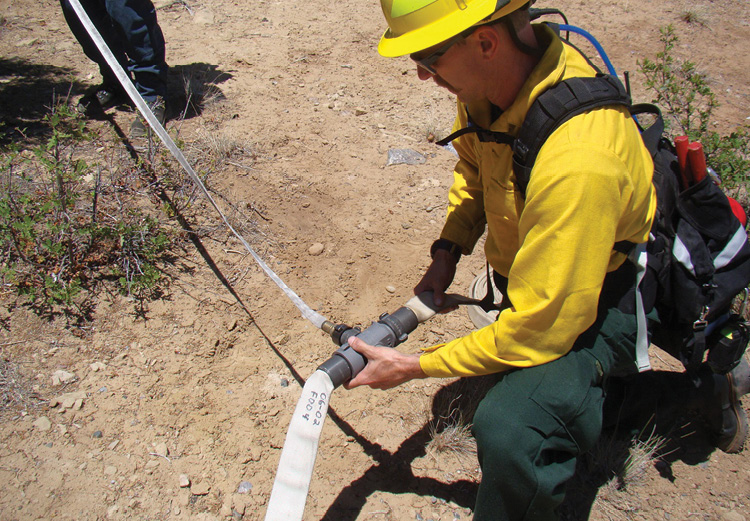 Firefighters prepare a progressive hoselay for a wildland fire. Structural firefighters must understand the similarities and differences in wildland fire tactics. (Photos by author.)