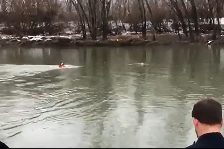 Firefighter swims out to victim during water rescue