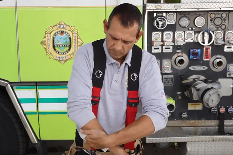 Firefighter using decon wipes