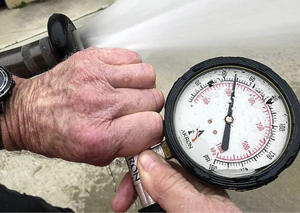 How a pitot tube is held in a nozzle’s stream will affect the result of a flow test. (Photo by Eric Goodman.)