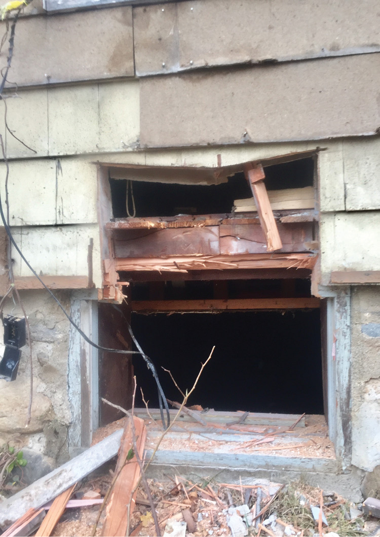 A basement window enlargement. More cutting may be necessary; however, the extra clearance gained may be sufficient to remove a down firefighter. 