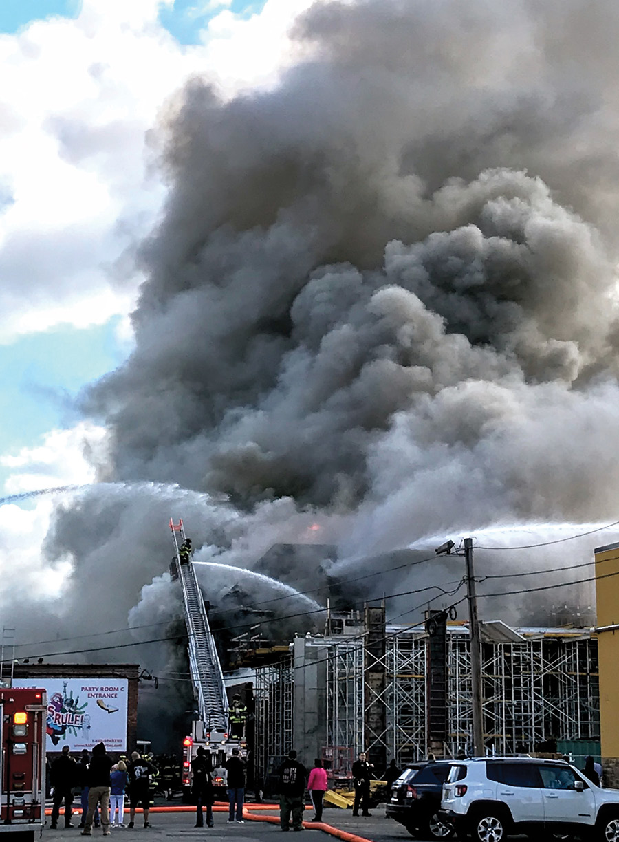 Master streams operate at the rear of the building, side C. Note the formwork of the building is under construction, exposing the fire building to the south (side B) and rear (side C). (Photo by Tony Greco.)