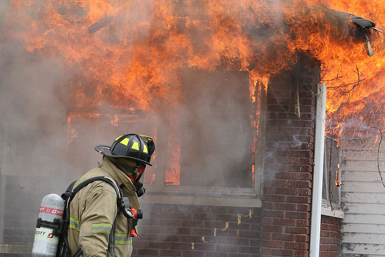 Firefighter confronts a fire