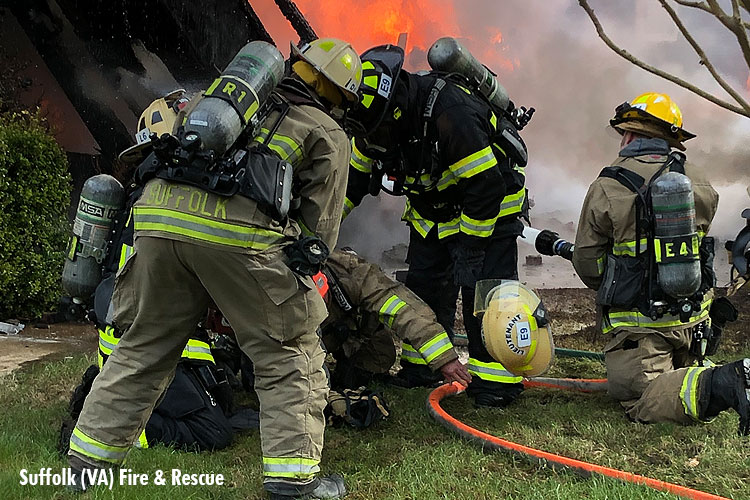 Firefighters attend to injured colleague