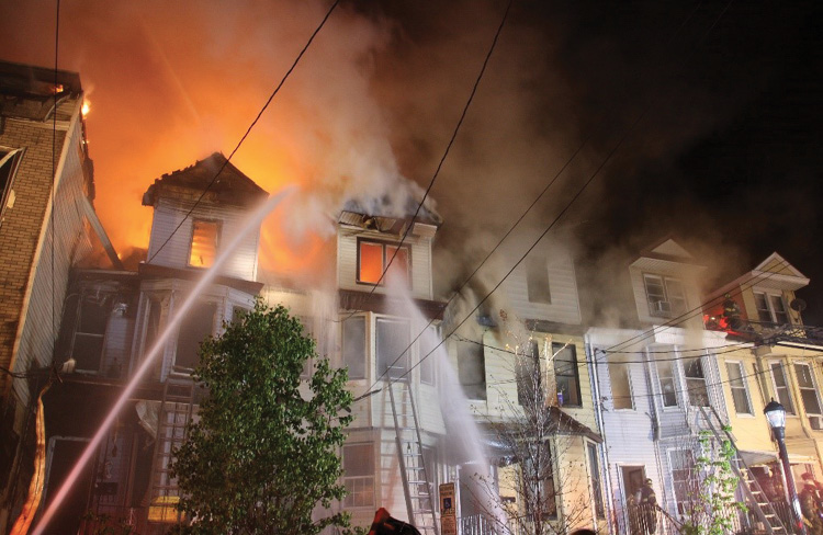 (3) Multiple strategic modes are in place at this incident. As the fire spreads toward the buildings on the D side, more aggressive interior operations (interior defensive) must take place to keep the fire confined to its present location and stop the spread. At this point, these buildings should all have been searched and evacuated, so the life focus now becomes one of firefighter safety, and the strategic focus centers on limiting damage. 