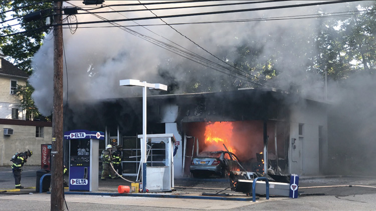 (1) The driver of the car on fire knocked over the gas pump and ran into the garage/office space of this service station. [Photo courtesy of the Ramsey (NJ) Fire Department/Ramsey Rescue Squad; all other photos by author.] 