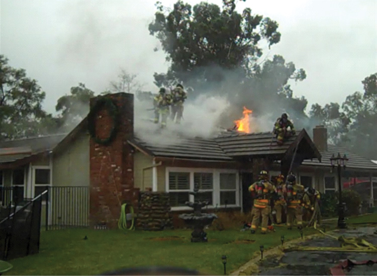 By the time fire was visible, Division A was established. Note the crews on the A side. The Division A supervisor was there at the front door, coordinating face-to-face with crews inside, on the roof, and approaching. The fresh crews had to check in with Division A prior to entry with an assignment. The radio traffic was minimal.