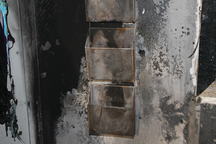 (1) This magazine rack was found in the fire debris on the floor. By leaving the item in the room and the gypsum board on the wall, the scene can be reconstructed to prefire conditions. (Photos by author.) 