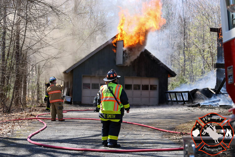 Fire pours from a window at a structure in Lake George