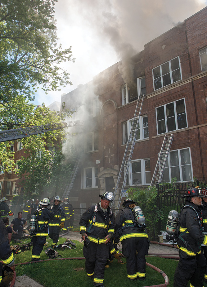 The front of the building as members are beginning offensive operations at an attached row type of private dwelling. (Photos by Gordon J. Nord Jr.) 