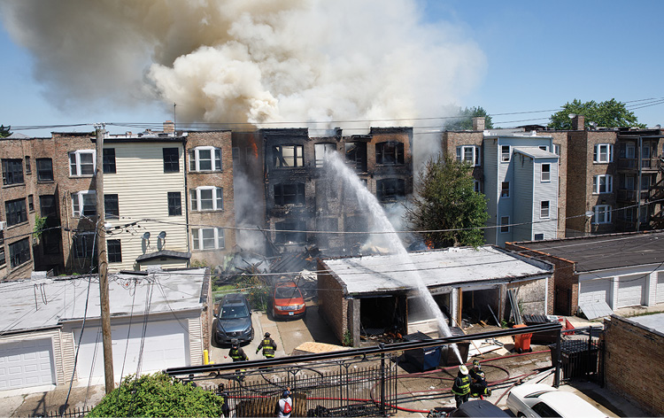 (5) The chief assigned to the rear withdrew members for the back out of the collapse zone. Handlines are now operated from beyond the collapse zone from a flanking position. 