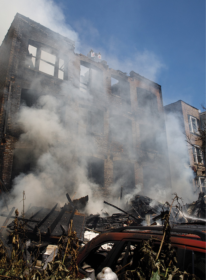 (7) We can see the amount of debris that has accumulated in the rear yard. Because of the nature of this type of construction, with a wooden rear porch, identifying the collapse zone is vital for the safety of all operating personnel.