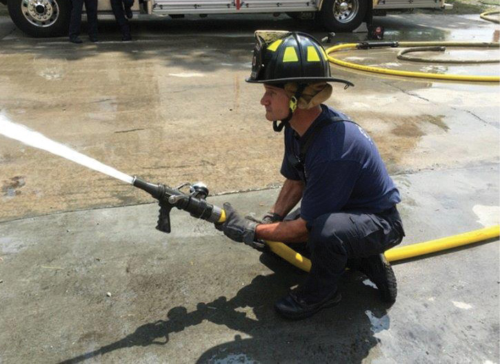 This firefighter is managing a hose and nozzle combination that matches. 