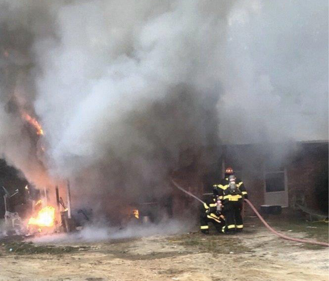 (4) In a rural setting, initial companies will be operating on their own. Hoseline position is extremely critical. Here, the engine crew was able to get a quick knock on this fire in a carport and then reposition the hoseline to the interior. (Photo by Clark McVey.)