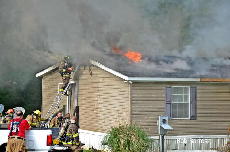 Firefighters work at the scene of a house fire