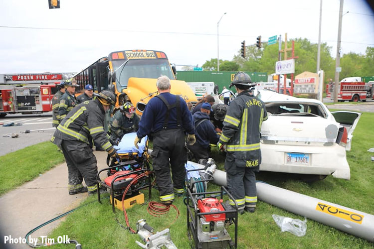 Firefighters work to free a person trapped in a crushed car