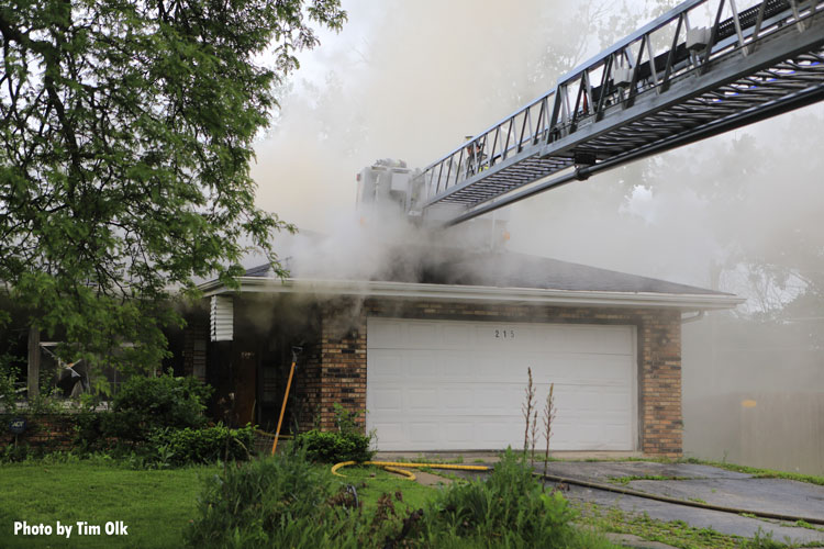 Tower ladder bucket over house fire