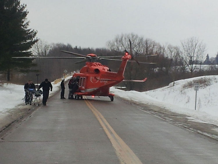 Crew members escort responders to helicopter