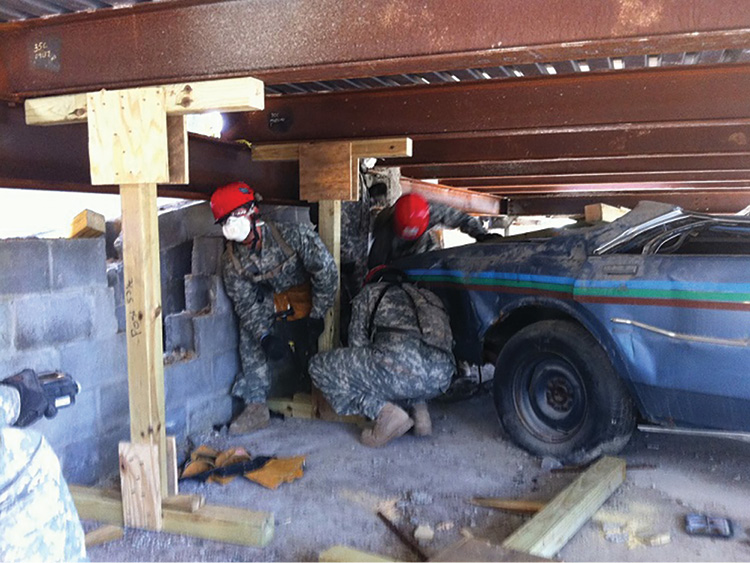 Military responders practice installing prebuilt spot shores in a parking garage. (Photo by Jeremy Rifflard.)