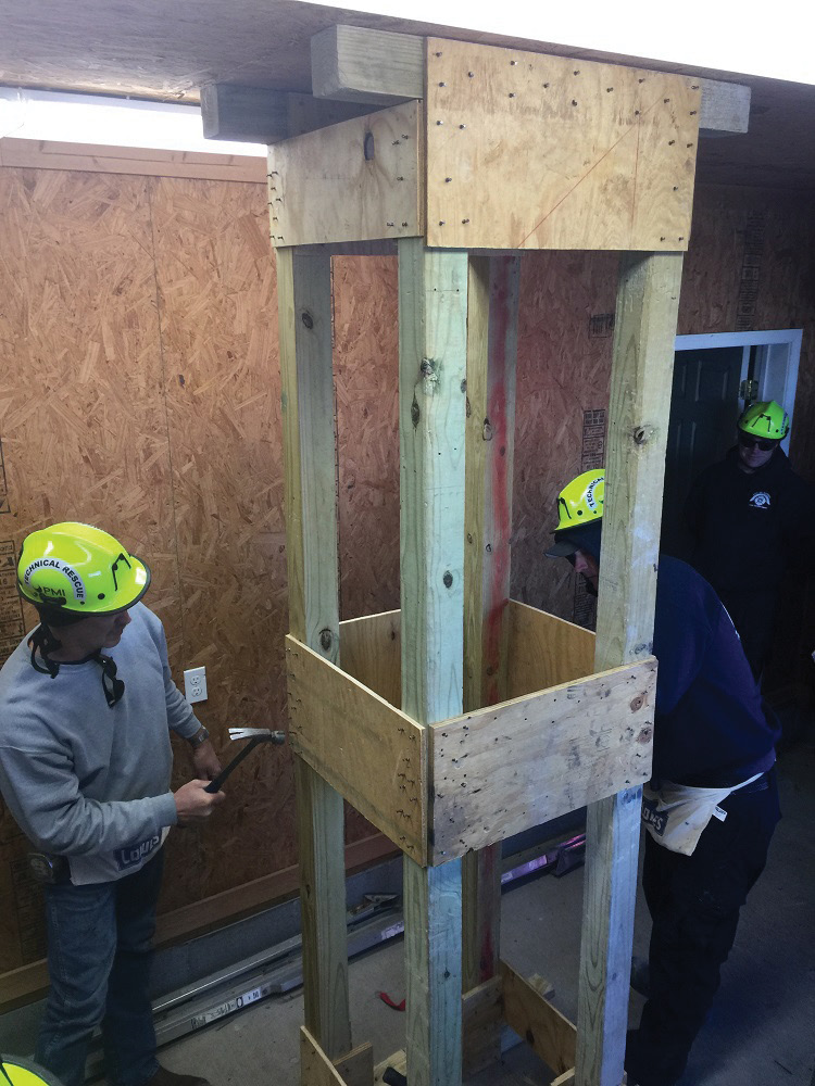 Murray (KY) Fire Department firefighters install and lace together two prebuilt double-T shores. (Photo by Jeremy Rifflard.)