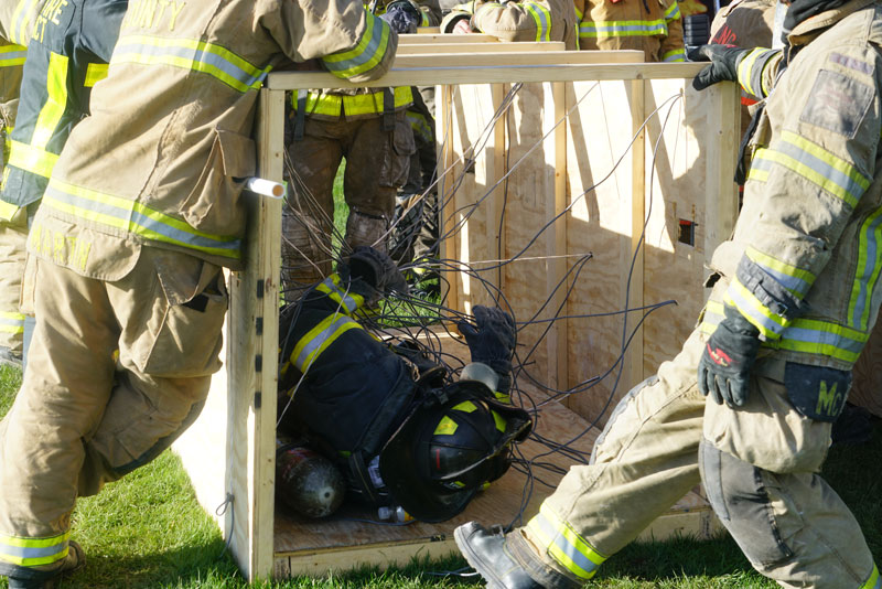 A firefighter trains on self-extrication after being entangled in wires