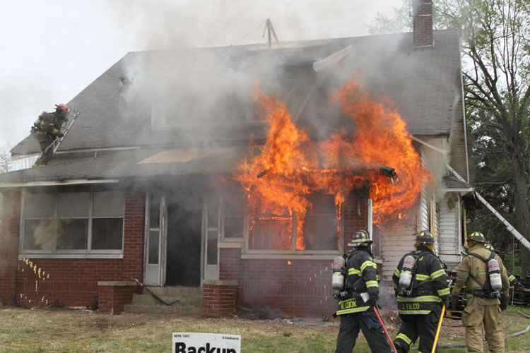 Firefighters conduct a training fire at an acquired structure