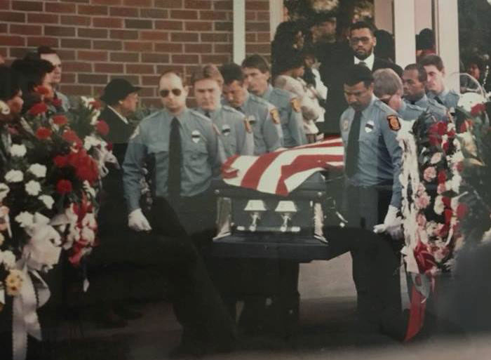 Fire department members and pallbearers escort City of Danville Firefighter Dennis DeShazor who was killed in the line of duty.