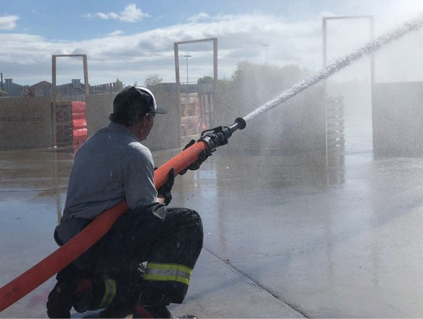 A ground-based hose handling position will increase the duration in which a nozzle firefighter is able to flow water. Allowing more of the hoseline to contact the ground will allow its weight and friction to aid in countering nozzle reaction. (Photo by author.) 