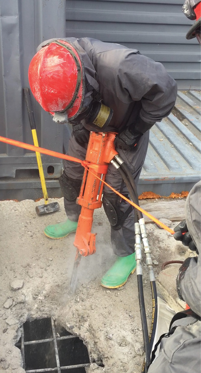 Georgia rescuers use a 45-pound breaker for a dirty breach. Notice webbing is attached to the tool to prevent it from falling into the hole.