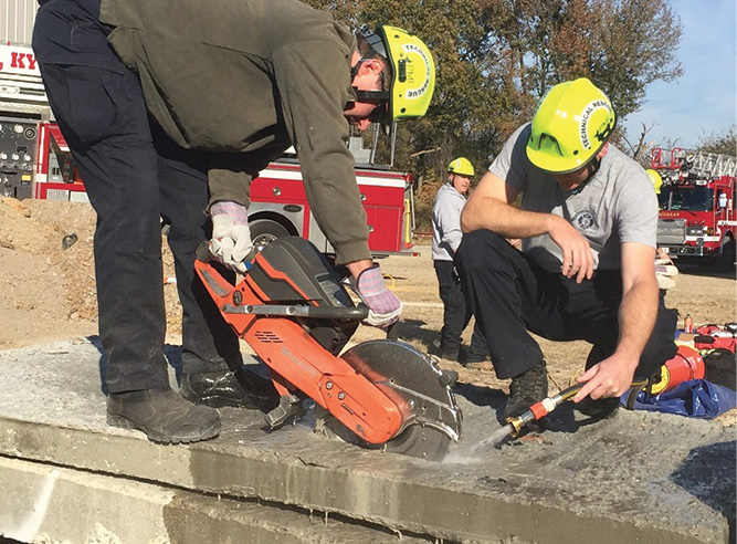 This slab is four inches thick. The rotary saw can be buried up to the arm, which will give these Murray (KY) Fire Department (MFD) firefighters about five inches of depth during the cut. This will allow a clean breach, bevel lift-out.