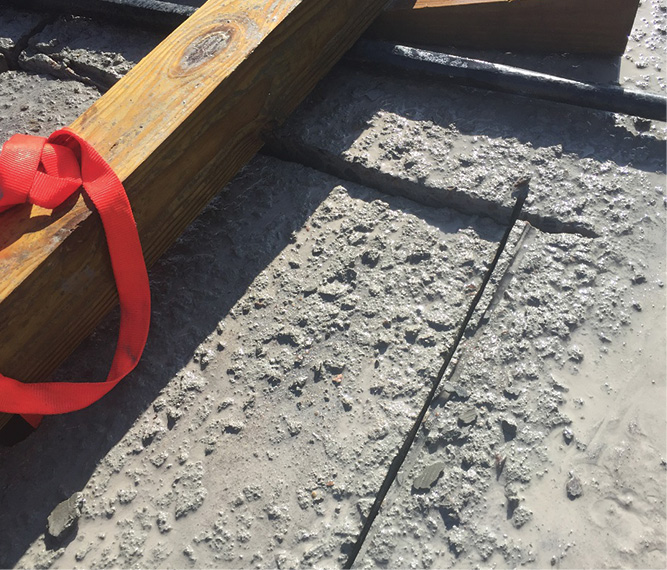 The concrete has been cut completely and has settled downward in the corner, which is a sign that you have cut through the full thickness of the slab.