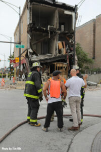 Chicago Fire Department members and others at the scene of the collapse.