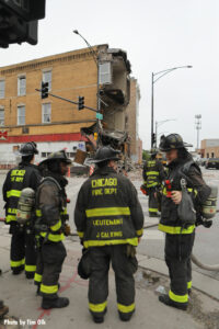 Members of the Chicago Fire Department confer about the incident.