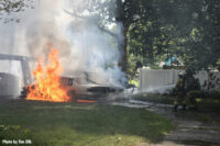 The fire spread to multiple vehicles and a fence.