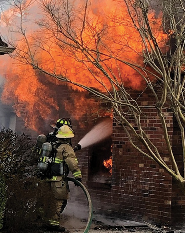 (3) The transitional attack on the garage through the B-side window.  (4) Engine 9’s crew advances an attack line into the door on the B side of the garage just prior to the structural collapse.