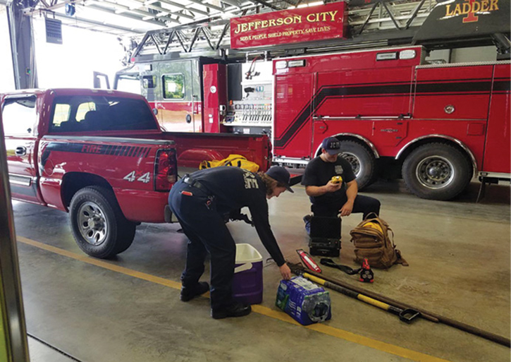 A roving crew is equipping a small vehicle with hand tools and supplies. (Photo by Ryan Carrendar.)