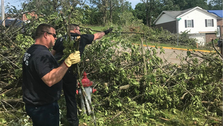 A roving crew clears storm debris from a fire hydrant in a vulnerable area to ensure access to a water supply. (Photo by Jerry Blomberg.) 