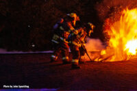 A team of firefighters opens up the roof.