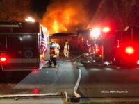 Apparatus and hoselines at the fire scene.