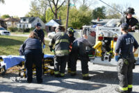 Firefighters rescuing a patient from the roof of a house