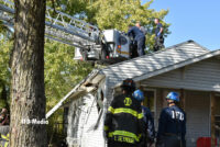 Firefighters operate out of a tower ladder bucket