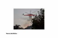 A helicopter makes a drop on the Tick Fire